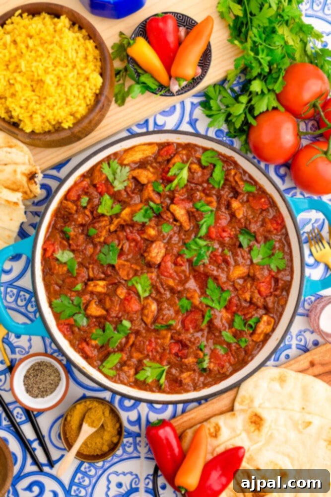 A vibrant bowl of homemade Chicken Madras Curry, garnished with fresh cilantro, ready to be served over rice.