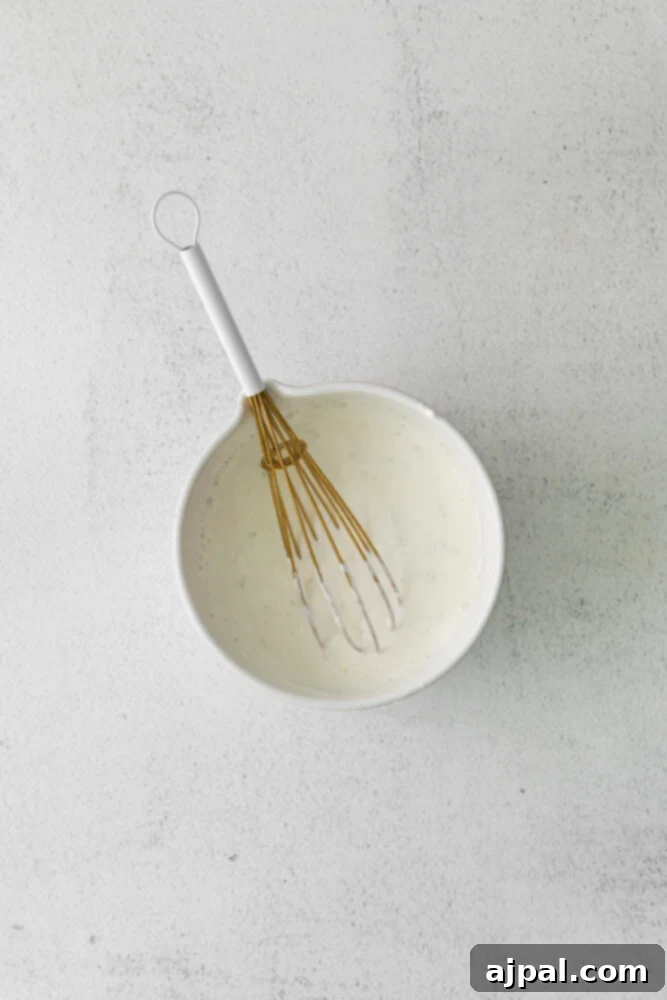 Your New Favorite Vegan Cauliflower Tacos 12 picture of crema in a white bowl being whisked