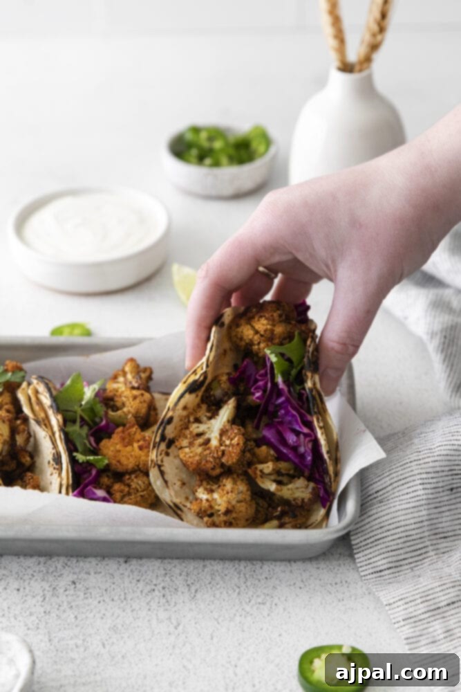 Your New Favorite Vegan Cauliflower Tacos 13 picture of cauliflower tacos with vegan crema and slaw in a metal tray