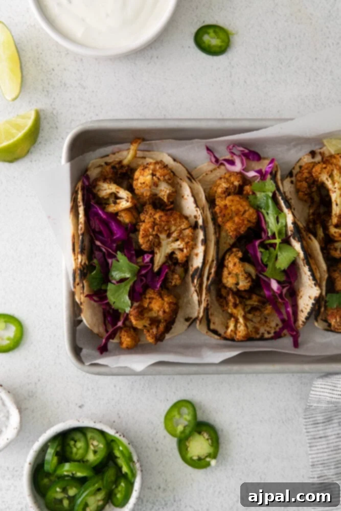 Your New Favorite Vegan Cauliflower Tacos 14 picture of cauliflower tacos with vegan crema and slaw in a metal tray