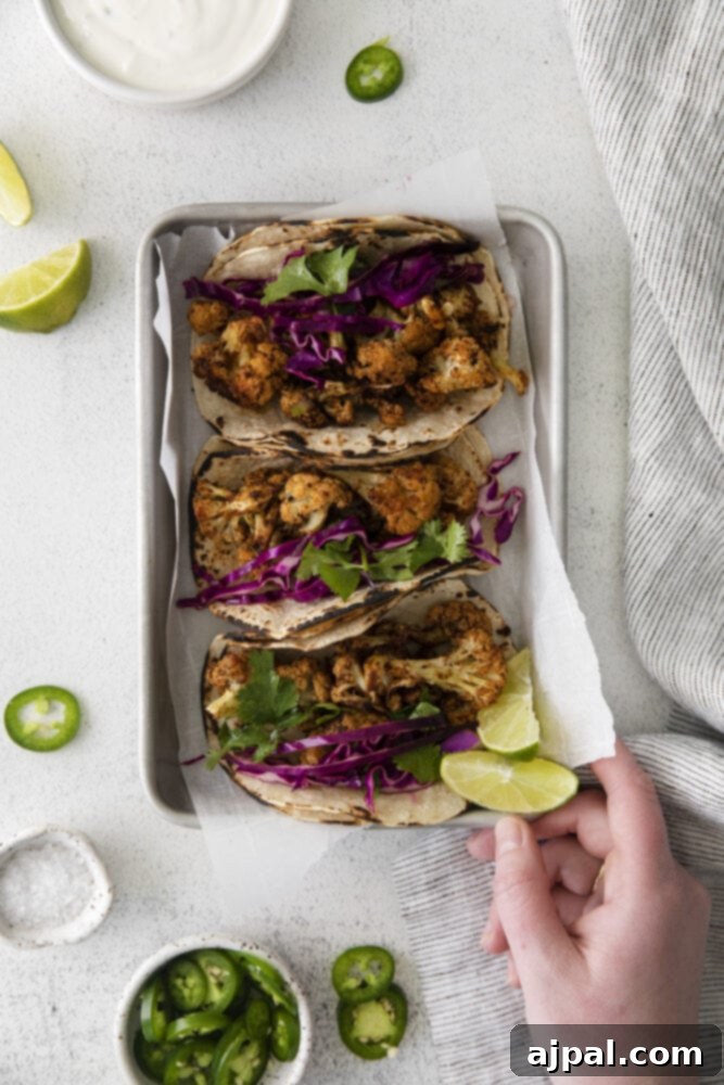 Your New Favorite Vegan Cauliflower Tacos 15 picture of cauliflower tacos with vegan crema and slaw in a metal tray