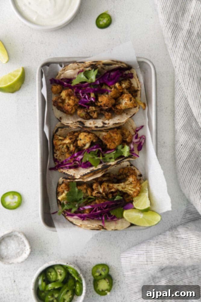 Your New Favorite Vegan Cauliflower Tacos 16 picture of cauliflower tacos with vegan crema and slaw in a metal tray