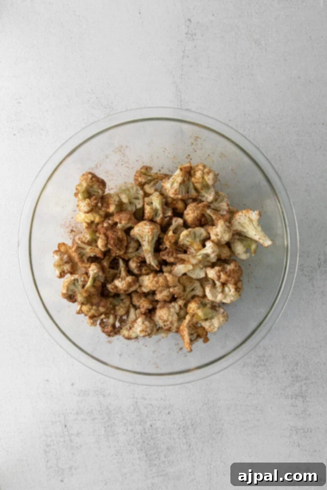 Your New Favorite Vegan Cauliflower Tacos 5 picture of cauliflower being tossed in spices