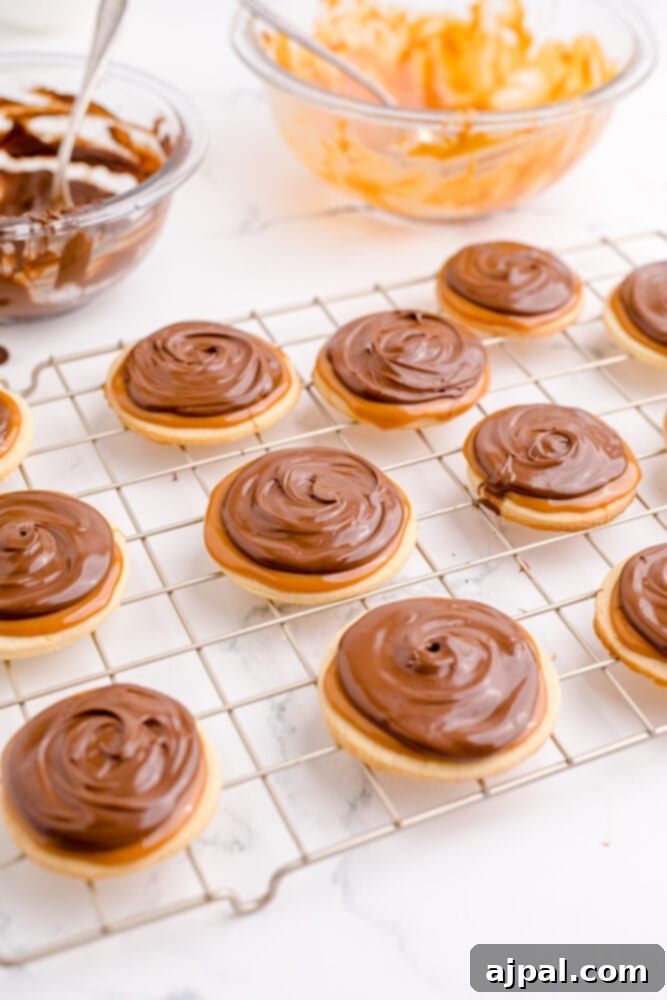 picture of cookies topped with caramel and chocolate, showing the final assembled Twix cookies.