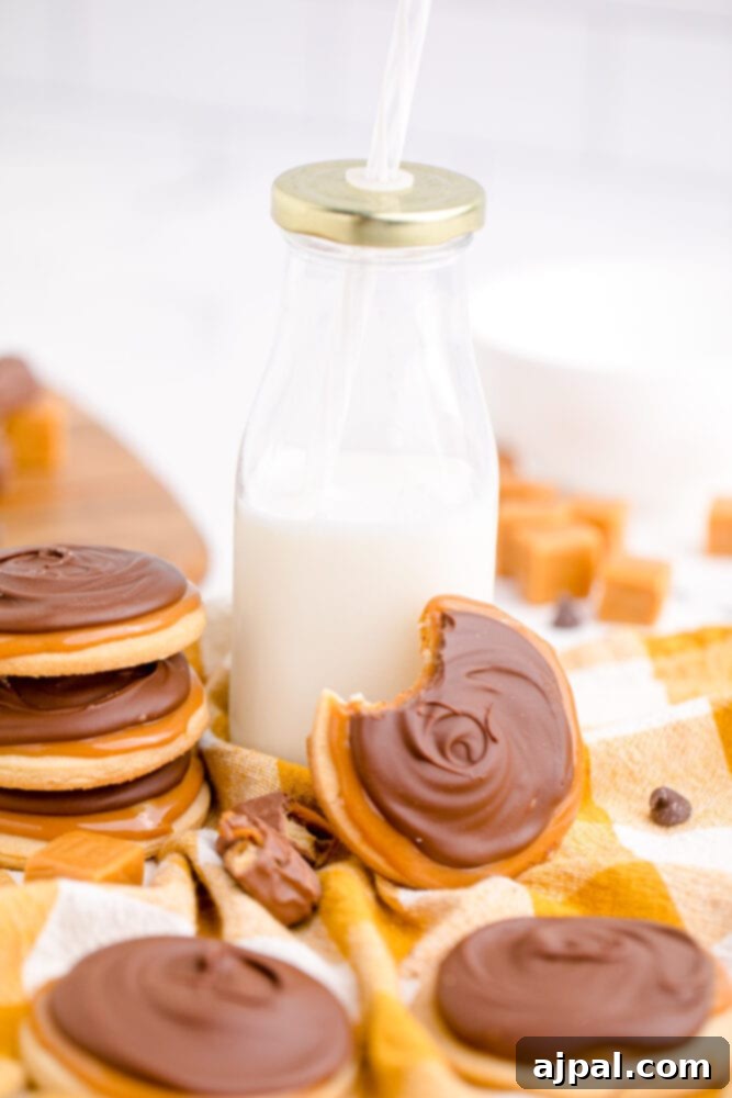 picture of a stack of Twix cookies, showing the layers of shortbread, caramel, and chocolate.