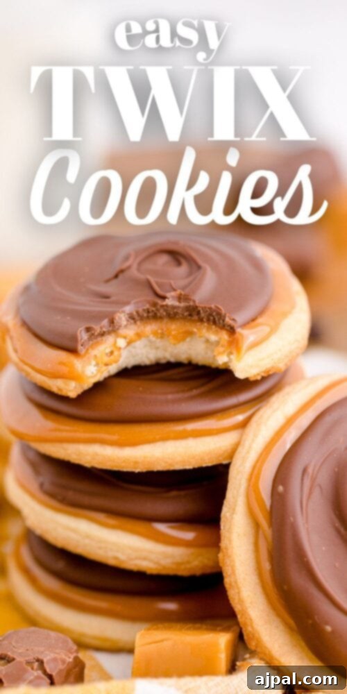 picture of a stack of twix cookies, neatly arranged, highlighting the layers of shortbread, caramel, and chocolate, with a bite taken out of one.