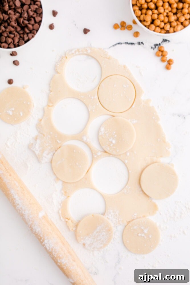 picture of circles cut out of shortbread cookie dough, ready for baking.