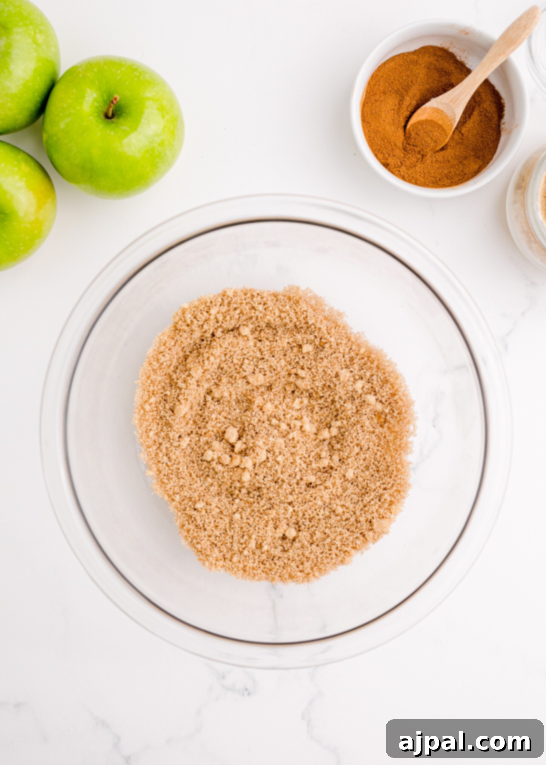 Picture of brown sugar and cinnamon being mixed in a bowl, prepared for the streusel-like topping.