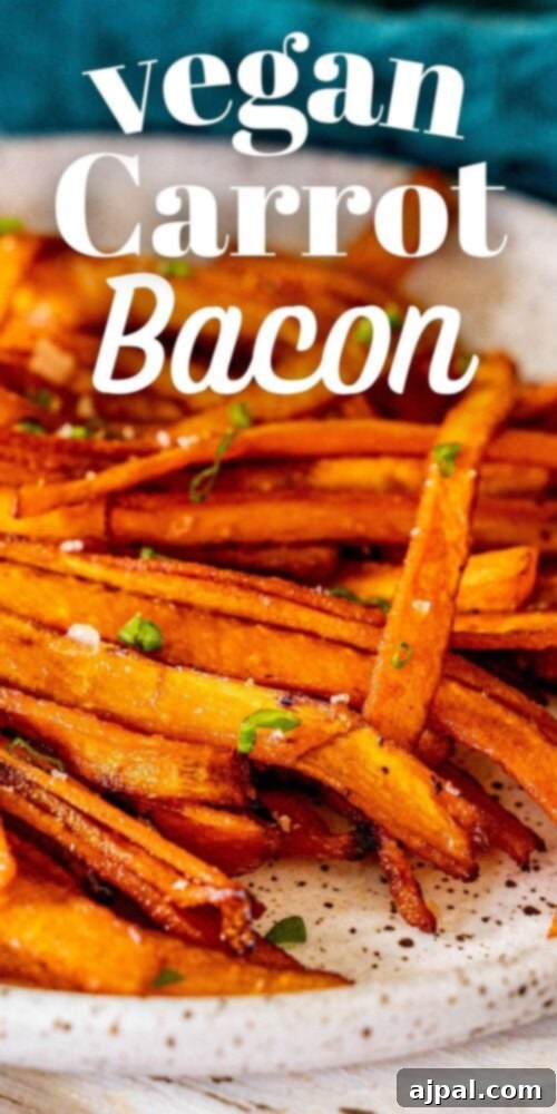 A high-angle shot of perfectly cooked vegan carrot bacon strips, beautifully presented on a plate, highlighting their crispy texture and savory appearance.