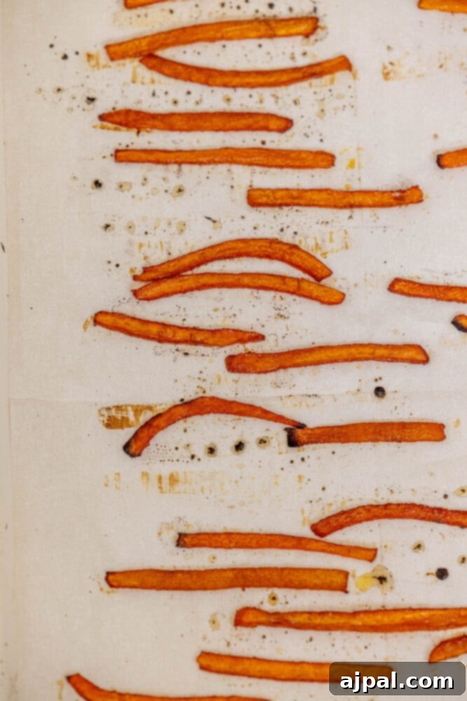 Freshly baked crispy vegan carrot bacon, golden brown and perfectly cooked, cooling on a baking sheet before serving.