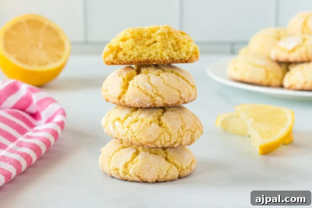 A wide shot of a plate brimming with golden lemon cake mix cookies, capturing their inviting texture and generous powdered sugar coating.