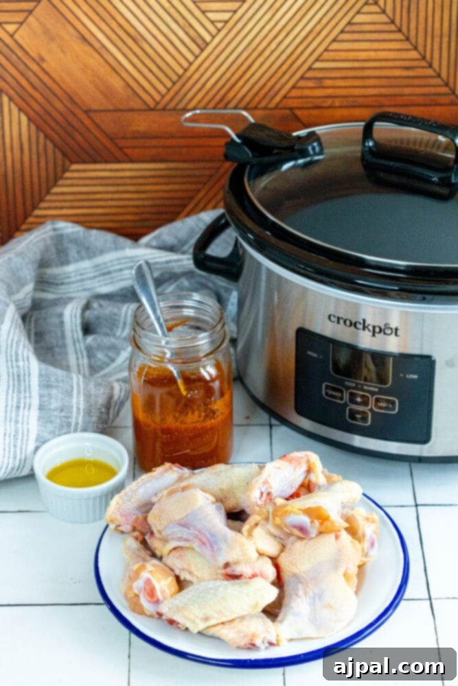 Smoky Tinga Slow Cooker Wings 4 Ingredients for Slow Cooker Chicken Tinga Wings: chicken wings, olive oil, and Tinga sauce, ready for preparation.