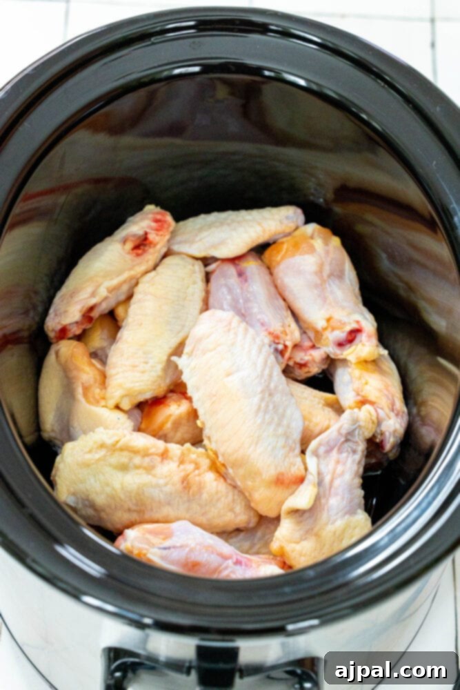 Smoky Tinga Slow Cooker Wings 5 Chicken wings placed inside a slow cooker, ready for the sauce.