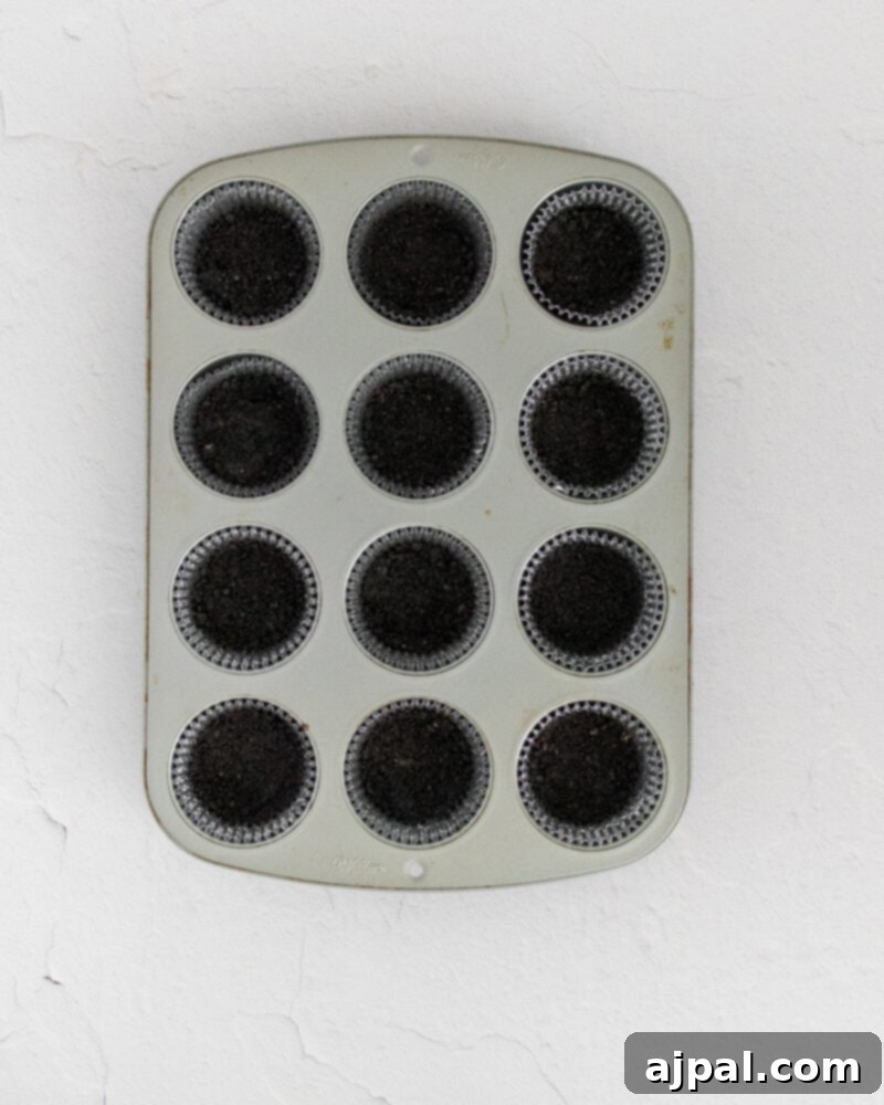 Easy No Bake Oreo Cheesecake 8 picture of oreo crumb base in a muffin pan