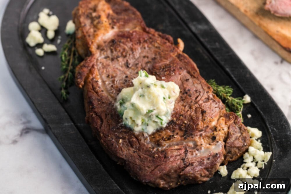 Juicy New York Strip steak topped with creamy blue cheese butter, ready to serve.