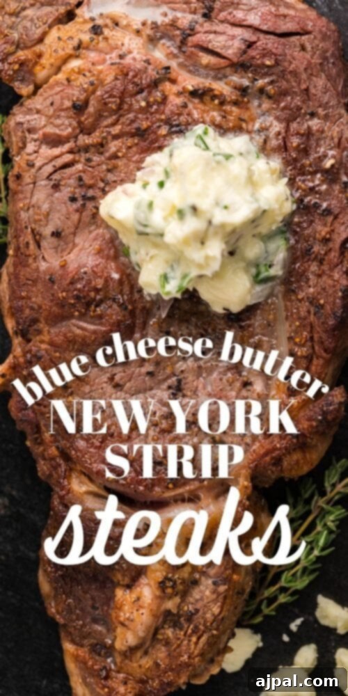 A tall, artistic shot of a New York Strip steak with blue cheese butter, showcasing the rich texture and garnishes.
