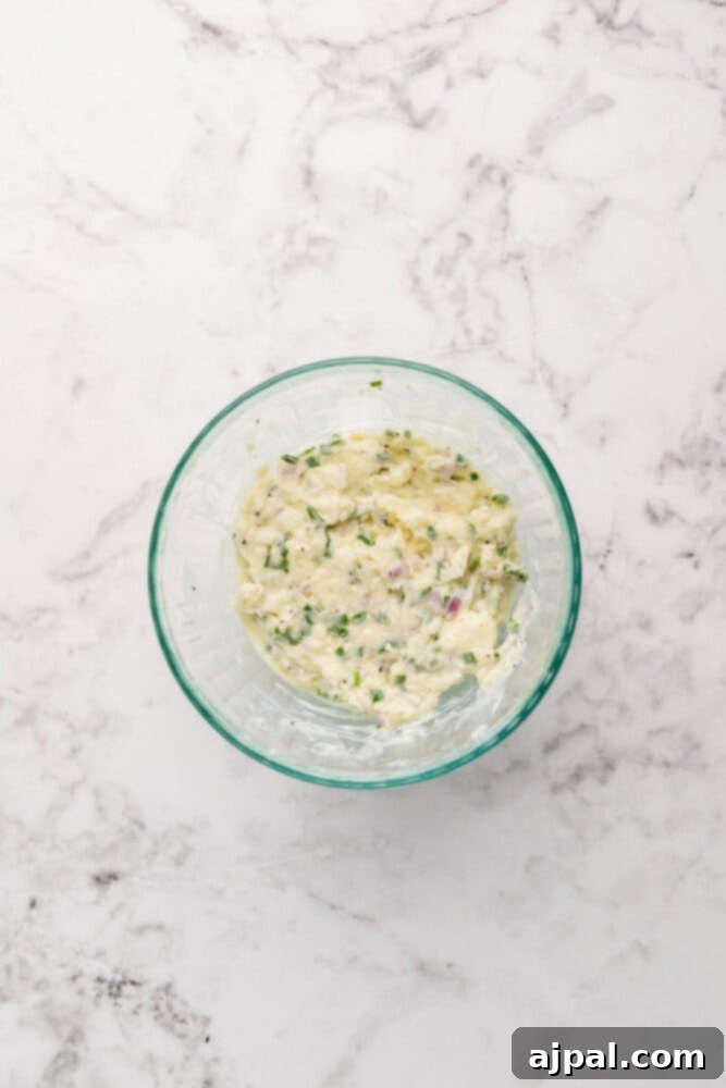 The freshly prepared blue cheese herb compound butter in a small bowl, ready to be used.