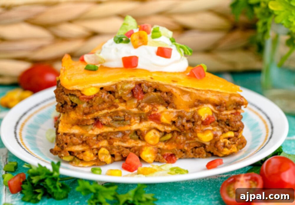 Hearty Taco Bake 2 A perfectly baked layered taco pie on a plate, showcasing its delicious layers.