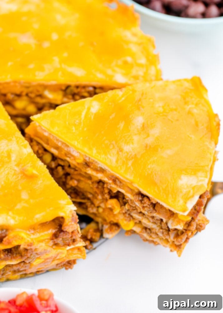 Hearty Taco Bake 4 A freshly baked layered taco pie, golden and bubbly, sliced and ready to serve.
