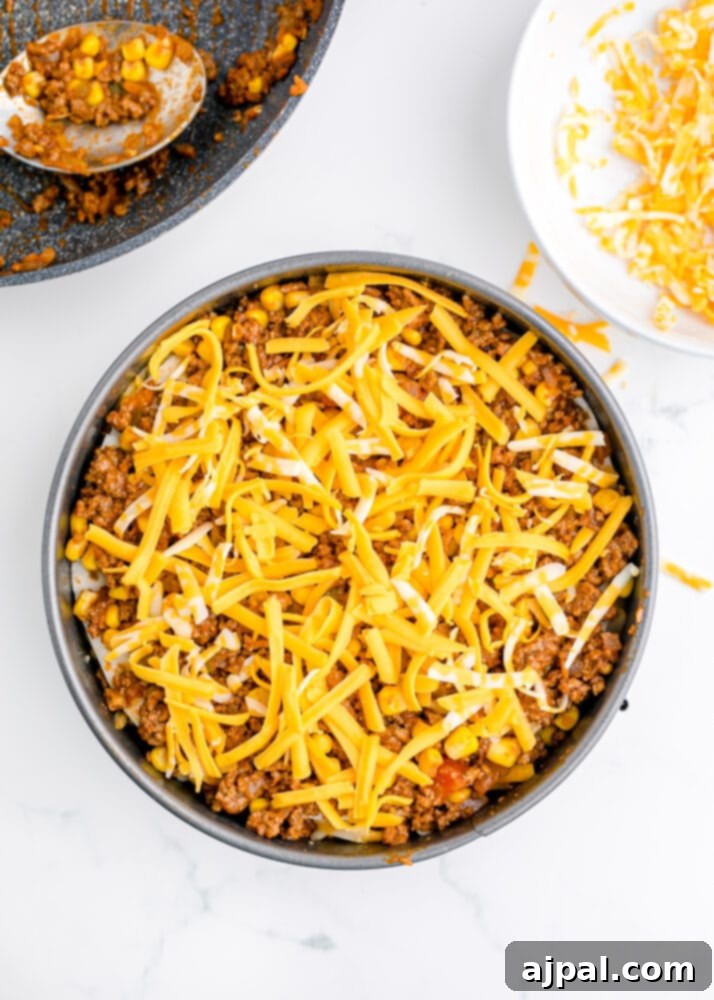 Hearty Taco Bake 10 Multiple layers of tortillas, meat, and cheese building up within the springform pan.