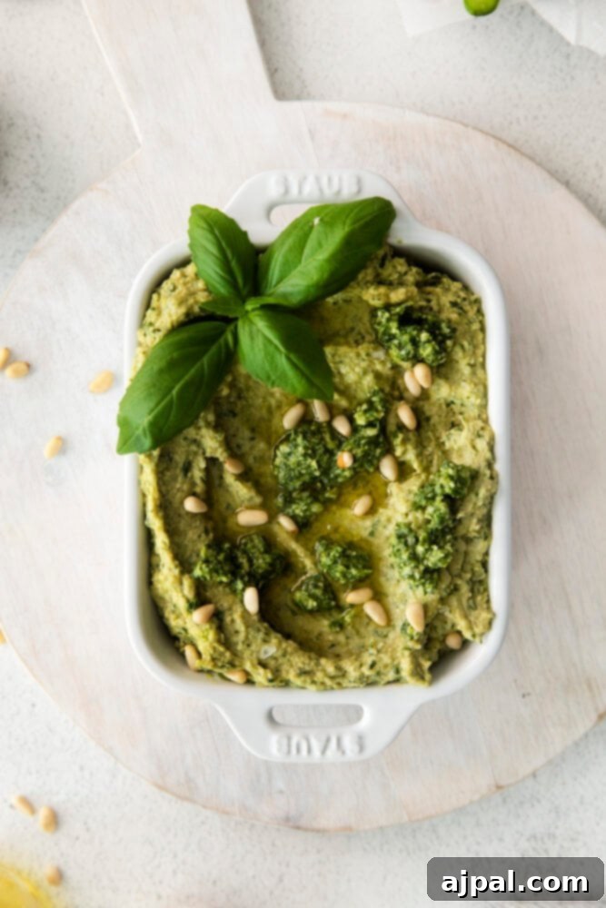 Vibrant Pesto Hummus 2 picture of pesto hummus in white bowl