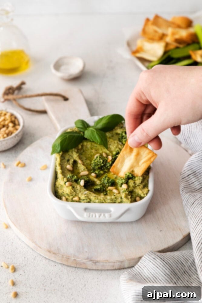 Vibrant Pesto Hummus 3 picture of pesto hummus in white bowl