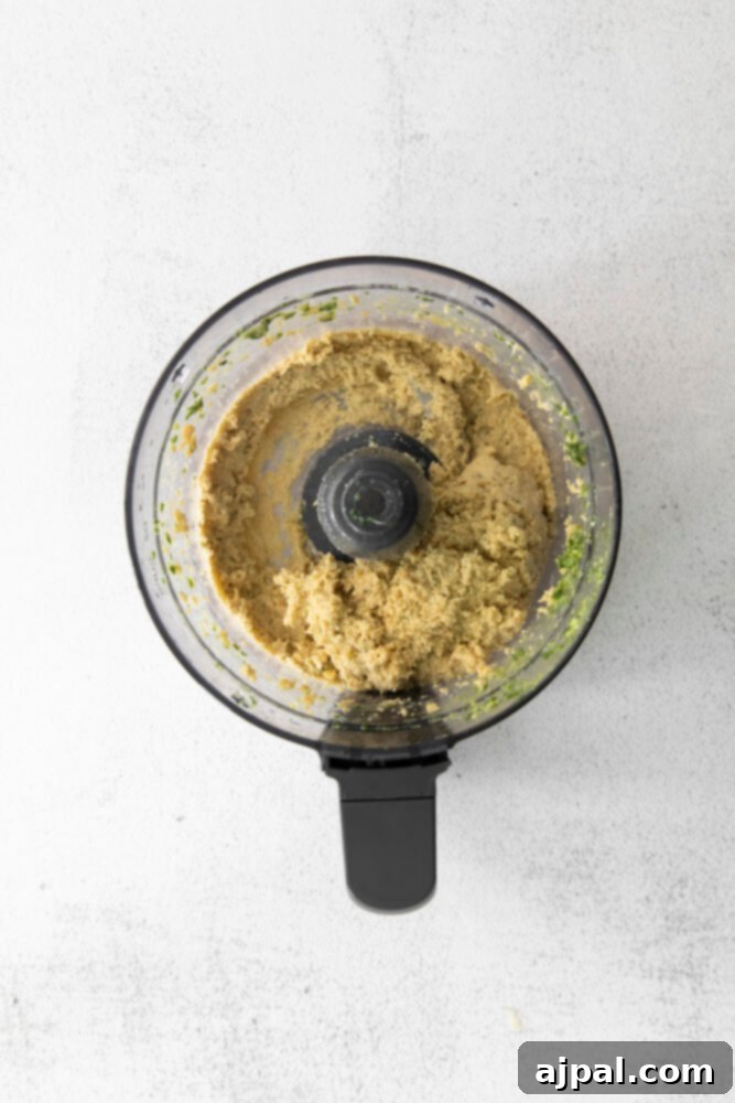Vibrant Pesto Hummus 6 picture of tahini and hummus in food processor