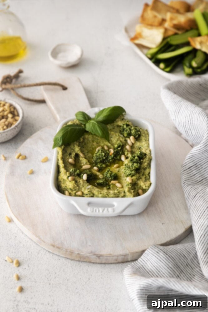 Vibrant Pesto Hummus 8 picture of pesto hummus in white bowl