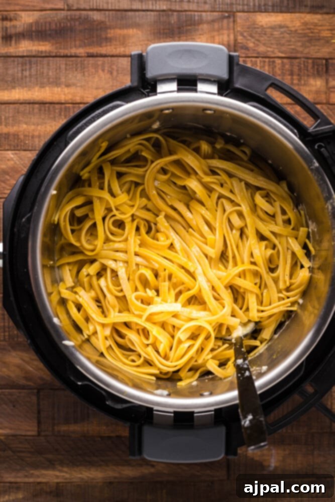 Instant Pot Creamy Lobster Brie Pasta 11 Perfectly cooked fettuccine noodles filling the Instant Pot, having absorbed all the rich liquid, ready for the sauce.