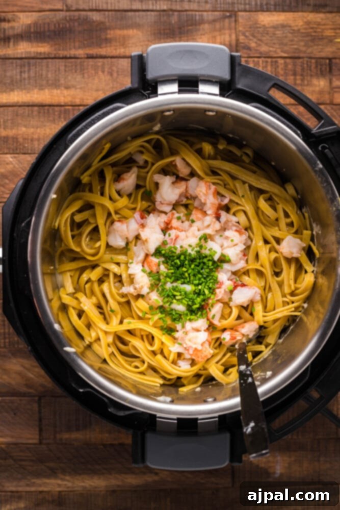 Instant Pot Creamy Lobster Brie Pasta 12 Tender pasta mixed with chopped lobster meat inside the Instant Pot, before the creamy brie sauce is added.