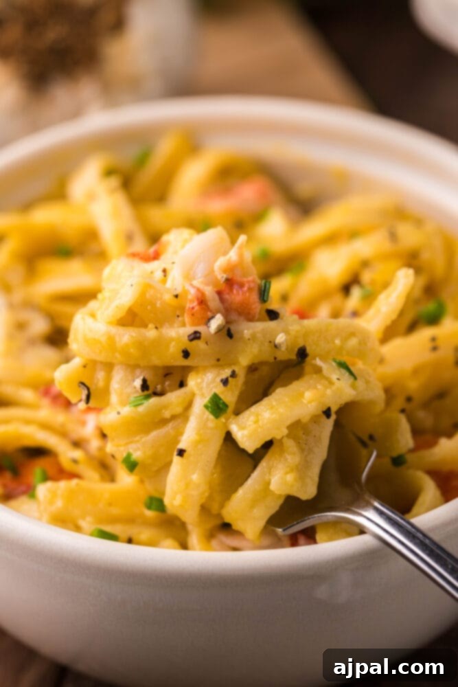 Instant Pot Creamy Lobster Brie Pasta 13 A large white bowl brimming with creamy Instant Pot Lobster Brie Pasta, garnished with fresh herbs, ready to be served.