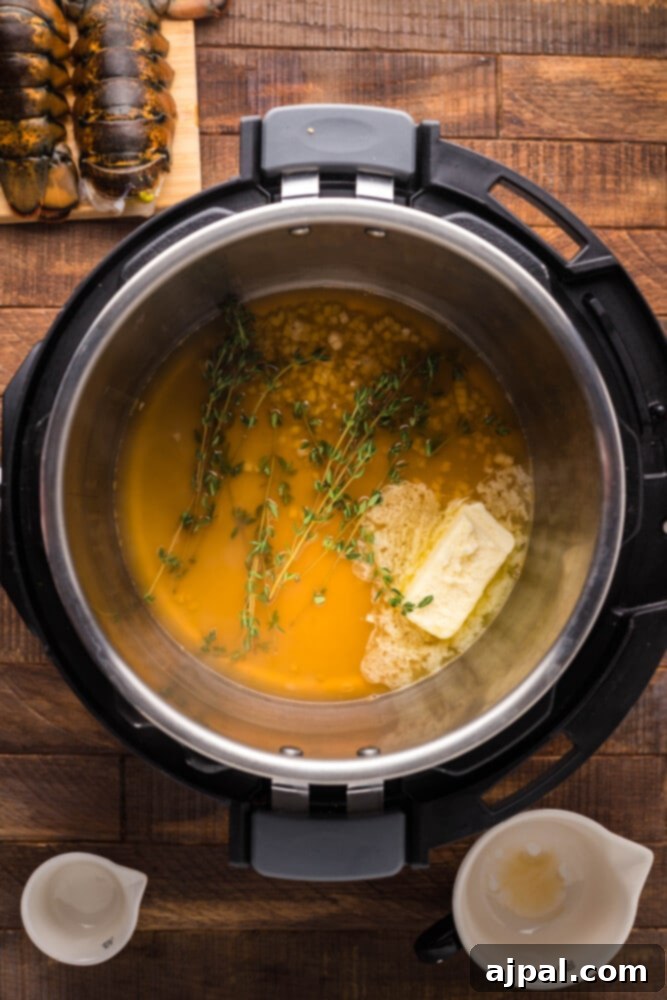 Instant Pot Creamy Lobster Brie Pasta 6 Inside view of an Instant Pot with vegetable broth and other liquids, preparing for the lobster and pasta to be added.