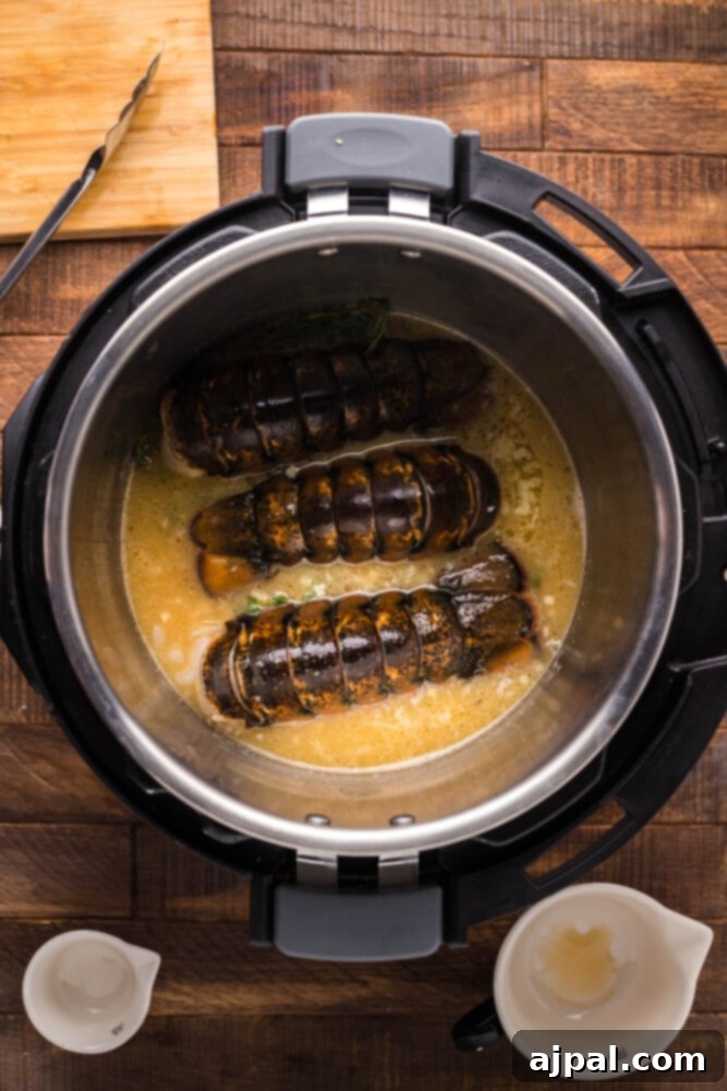 Instant Pot Creamy Lobster Brie Pasta 7 Fresh lobster tails carefully placed into the Instant Pot, ready to cook in the savory liquid mixture.
