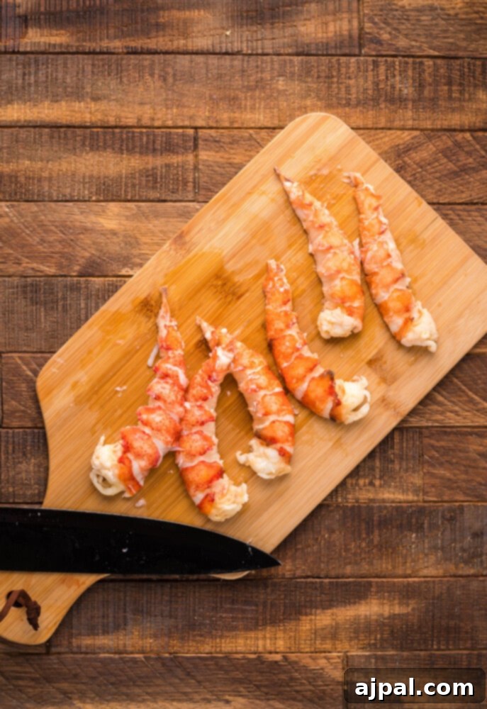 Instant Pot Creamy Lobster Brie Pasta 9 Cooked lobster tails, removed from the Instant Pot and placed on a wooden chopping board, ready for the meat to be extracted.