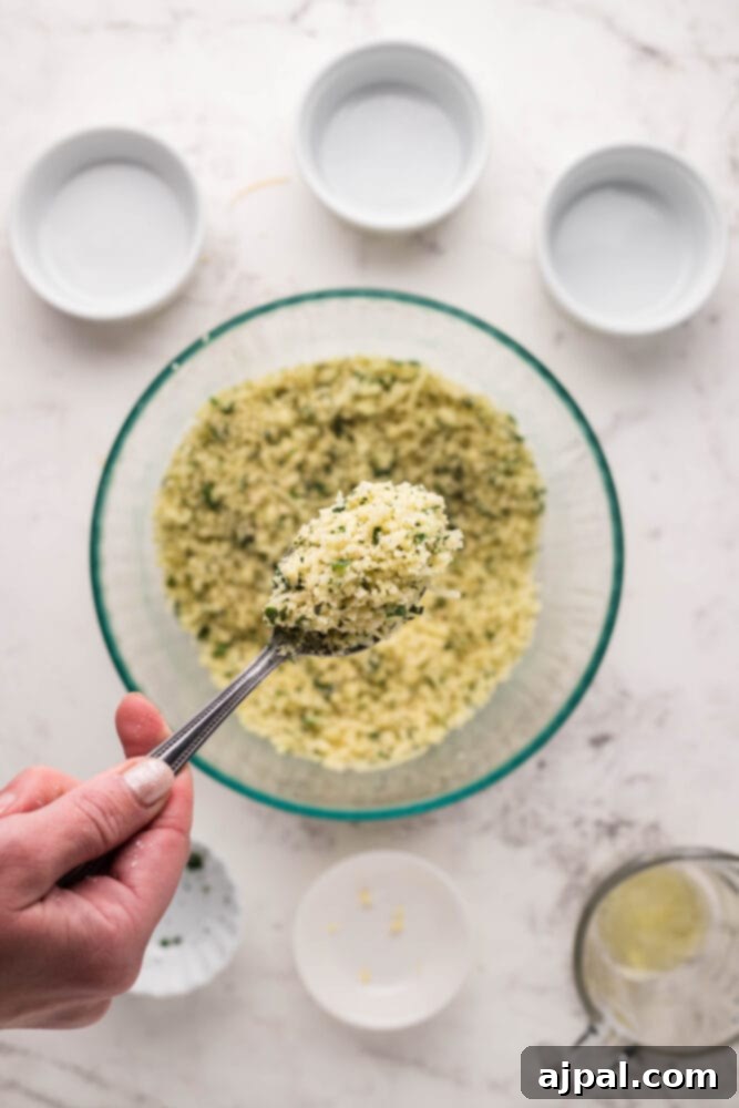 A spoon scooping a generous amount of the Parmesan breadcrumb mixture, showcasing its perfect texture.