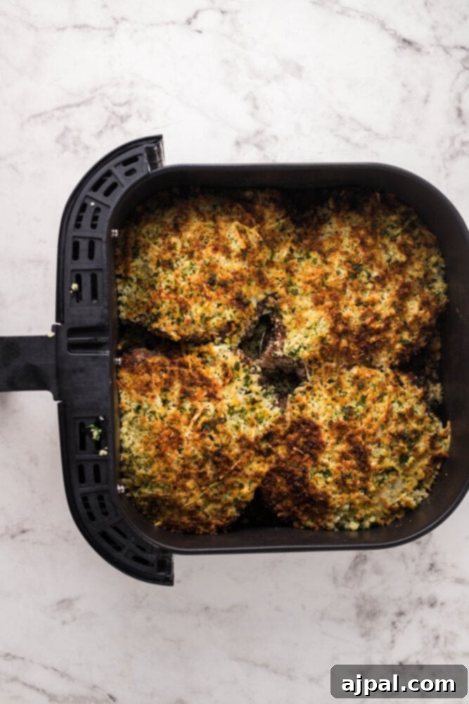Air Fryer Longhorn Style Parmesan Crusted Steak 14 picture of herb breadcrumb topped steaks in an air fryer