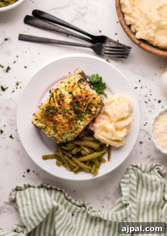Air Fryer Longhorn Steakhouse Parmesan Crusted Steak served beautifully on a white plate with creamy mashed potatoes and vibrant green beans.