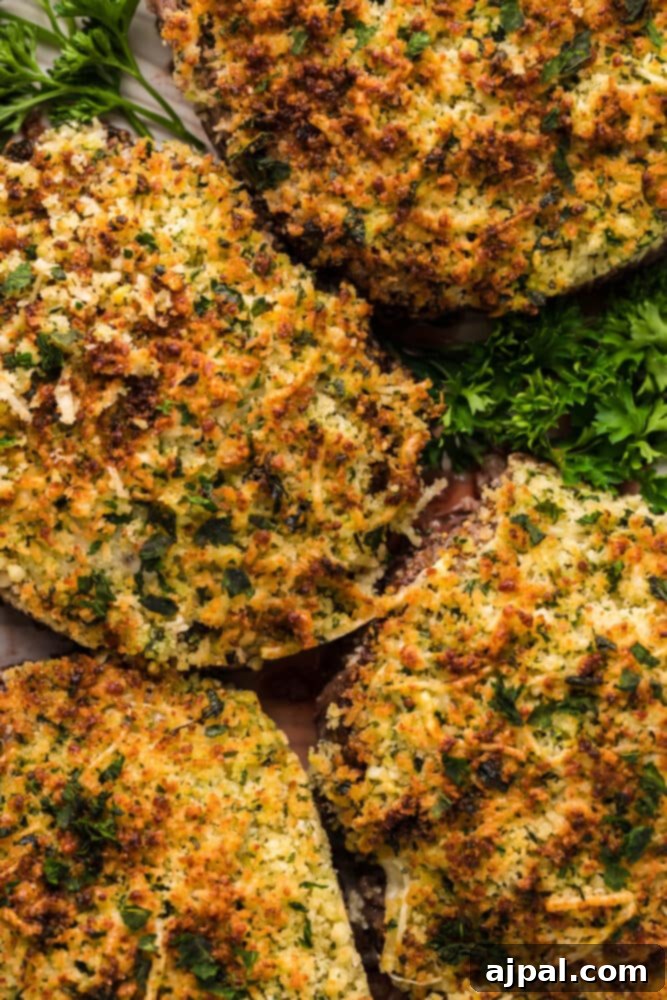 Fried stuffed mushrooms on a plate with herbs, accompanying a parmesan crusted steak recipe.