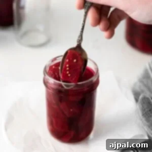 picture of pickled beets in a jar with a spoon