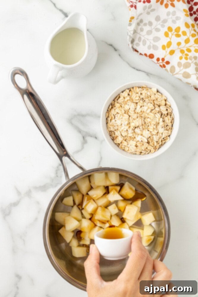 A person pouring apple cinnamon oatmeal ingredients into a pan.