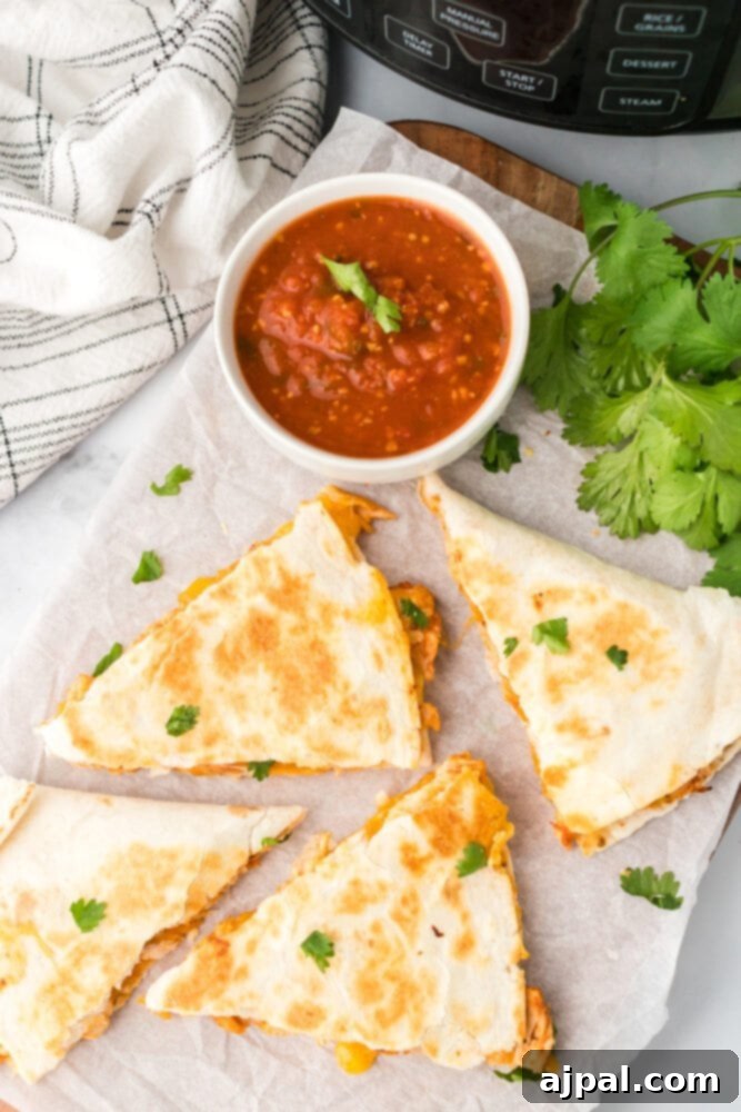 Crispy chicken quesadillas served on a cutting board, with an Instant Pot in the background