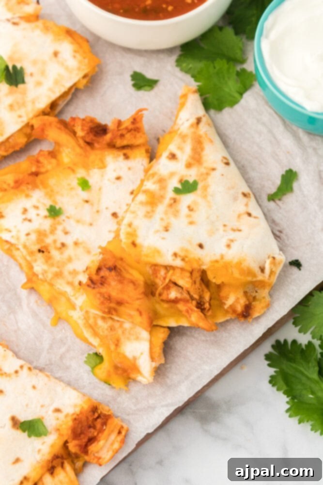 Freshly prepared chicken quesadillas on a cutting board, ready to be served