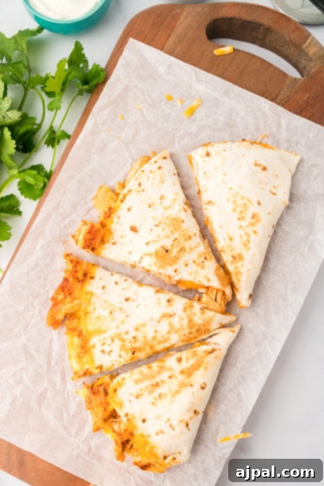 A freshly cooked chicken quesadilla sliced into perfect triangles