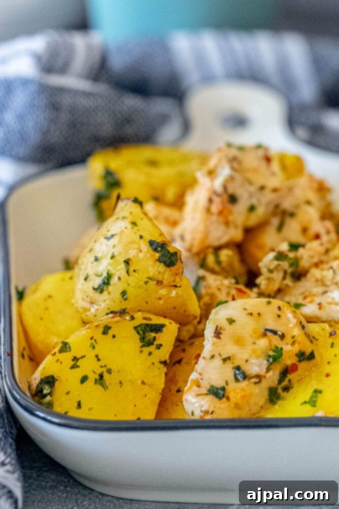 Zesty Lemon Garlic Chicken with Roasted Potatoes 2 Lemon garlic chicken and potatoes in a white dish, ready to be served.