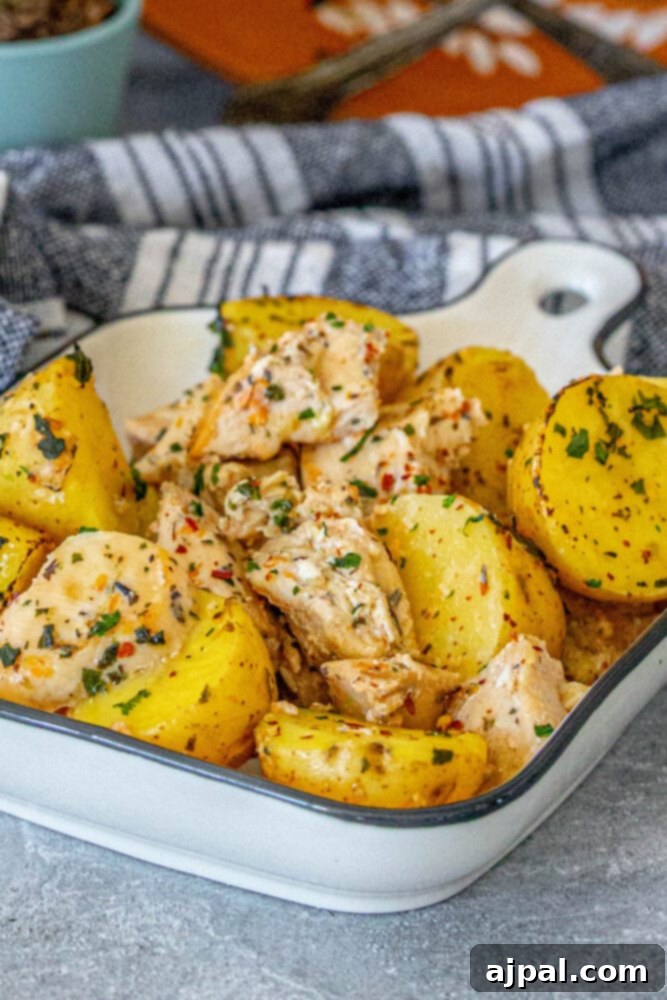 Zesty Lemon Garlic Chicken with Roasted Potatoes 3 Baked garlic lemon chicken and potatoes presented beautifully in a white serving dish.