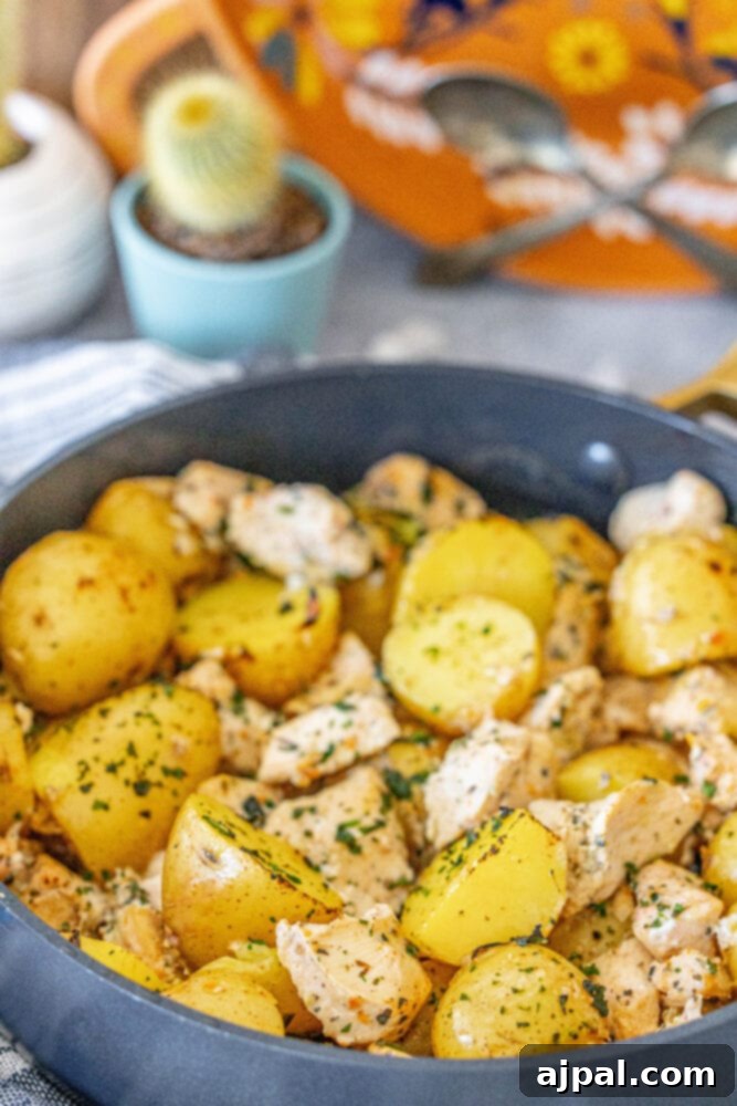 Zesty Lemon Garlic Chicken with Roasted Potatoes 5 Baked chicken and potatoes sizzling in a pan, fresh out of the oven.