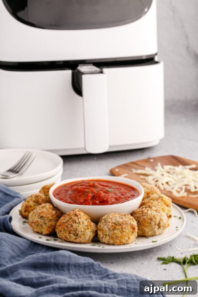 picture of air fryer arancini ball on a plate with sauce