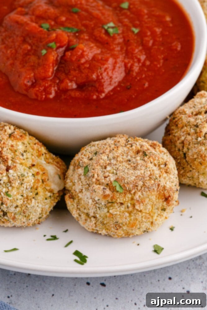 picture of air fryer arancini ball on a plate with sauce