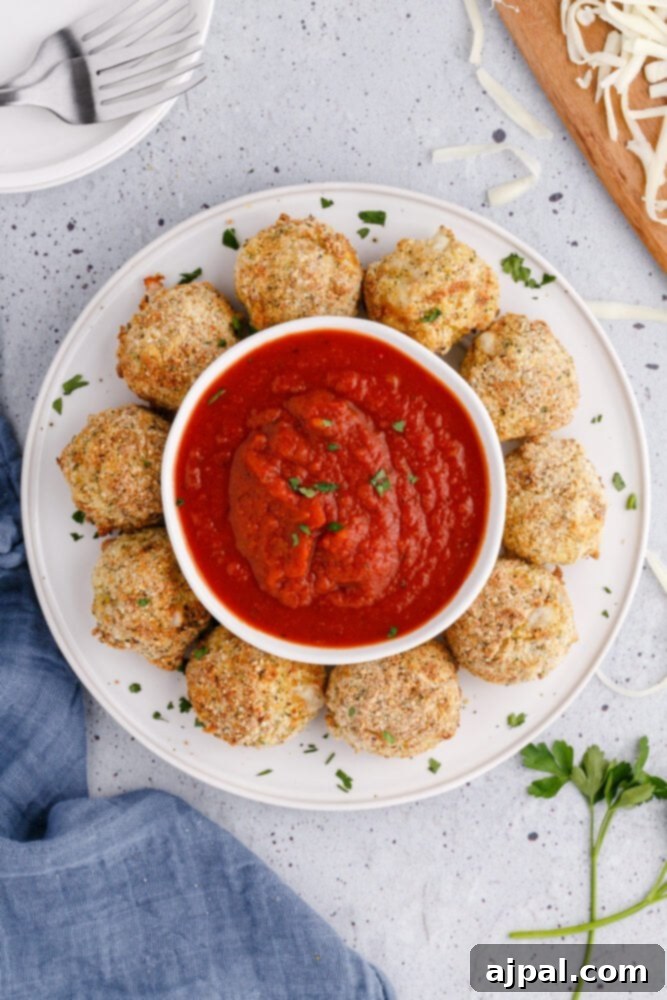 picture of air fryer arancini ball on a plate with sauce