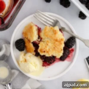 A beautifully baked blackberry cobbler in a dish, showing a perfect golden crust.